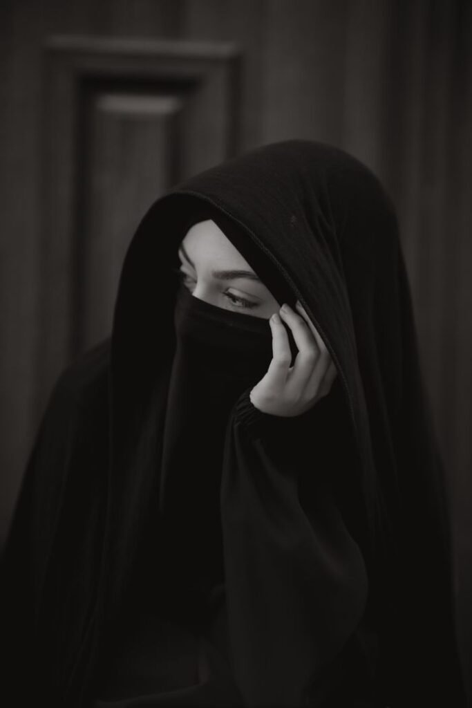 Portrait of a woman in a black hijab, conveying mystery and tradition.
